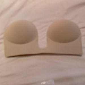 Backless adhesive bra with two nipple covers. Fits a C to a D cup.